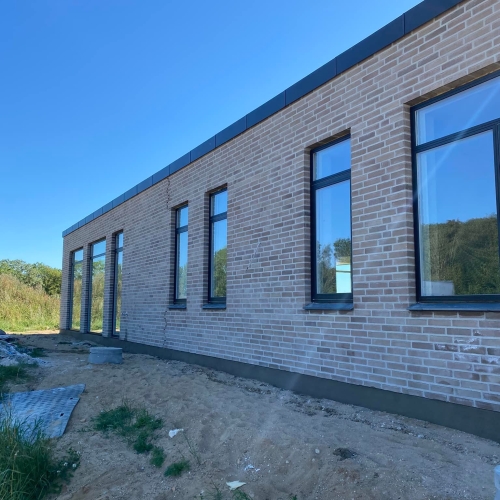 Lang facade med mange vinduer i moderne nybyg i Aarhus.